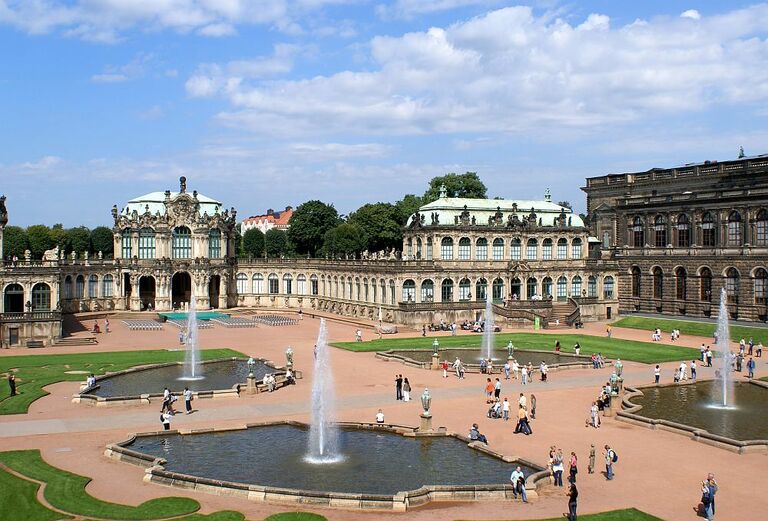 Der Innenraum des Dresdener Zwinger mit vielen Besuchern und den vier Brunnen.